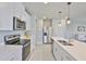 Stylish kitchen showcasing stainless steel appliances, white cabinets, and a sleek countertop at 7709 Imagination Pl, Wesley Chapel, FL 33545