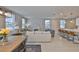 Open-concept living space with modern furnishings and a sleek kitchen island at 7709 Imagination Pl, Wesley Chapel, FL 33545