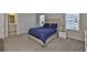 Comfortable main bedroom with carpet, two windows and two bedside tables at 7709 Imagination Pl, Wesley Chapel, FL 33545