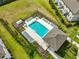 Aerial shot of community pool and clubhouse, surrounded by greenery and seating for residents at 7709 Imagination Pl, Wesley Chapel, FL 33545