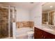 Bright bathroom with marble tile accents, tub, shower, and granite countertop at 777 N Ashley Dr # 2608, Tampa, FL 33602