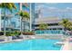 Gorgeous rooftop pool with a waterfall feature, surrounded by palm trees and lounge chairs at 777 N Ashley Dr # 2608, Tampa, FL 33602