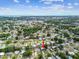 An aerial view of a neighborhood with tree-lined streets, with an arrow pointing to the location of the property at 8528 Iris Ave, Seminole, FL 33777