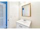Bathroom featuring vanity with a sink, gold-framed mirror and neutral walls at 8528 Iris Ave, Seminole, FL 33777
