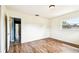 Bedroom with laminate wood floors, large window, and overhead lighting at 8528 Iris Ave, Seminole, FL 33777