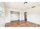 This bedroom features wood-look floors, a closet and an ensuite bath at 8528 Iris Ave, Seminole, FL 33777