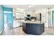 Modern kitchen with white cabinets, stainless steel appliances, granite countertops, and a center island at 8528 Iris Ave, Seminole, FL 33777