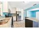 Updated kitchen features stainless steel appliances, granite countertops, and bright white cabinetry at 8528 Iris Ave, Seminole, FL 33777