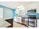 Updated kitchen featuring stainless steel appliances, granite countertops, and classic white cabinetry at 8528 Iris Ave, Seminole, FL 33777