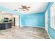 Spacious open living area featuring wood-look floors, bright light, and a view of the kitchen at 8528 Iris Ave, Seminole, FL 33777