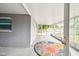 Enclosed patio with a colorful rug and access to the backyard at 8528 Iris Ave, Seminole, FL 33777