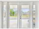 Double doors leading to a patio with a view of a swing set at 8528 Iris Ave, Seminole, FL 33777