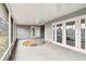 Enclosed patio includes a colorful rug and an entrance to backyard at 8528 Iris Ave, Seminole, FL 33777