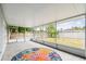 Enclosed patio with a colorful rug and backyard view, bright space at 8528 Iris Ave, Seminole, FL 33777