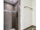 Shower with sleek dark tiling and modern fixtures at 8528 Iris Ave, Seminole, FL 33777