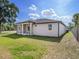 The home features a covered patio, and a large backyard at 9416 Bullfrog Court, Gibsonton, FL 33534