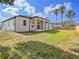 The home features a covered patio, and a large backyard with palm trees at 9416 Bullfrog Court, Gibsonton, FL 33534