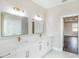 Bright bathroom with a double vanity, white cabinets, and modern fixtures at 9416 Bullfrog Court, Gibsonton, FL 33534