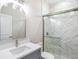 Elegant bathroom featuring a glass-enclosed shower with marble tile and modern fixtures at 9416 Bullfrog Court, Gibsonton, FL 33534
