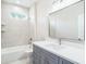 Bright bathroom with sleek vanity, tub, and tiled shower, offering a spa-like experience at 9416 Bullfrog Court, Gibsonton, FL 33534