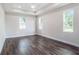 Large bedroom featuring wood floors, trey ceiling, recessed lighting, and bright windows at 9416 Bullfrog Court, Gibsonton, FL 33534