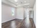 Spacious bedroom with wood floors, tray ceiling, recessed lights, and a large window at 9416 Bullfrog Court, Gibsonton, FL 33534