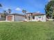 Charming single-story home featuring a well-manicured lawn, two-car garage, and neutral color scheme at 9416 Bullfrog Court, Gibsonton, FL 33534