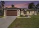 Beautiful single-story home with a well-maintained lawn, a two-car garage and manicured landscaping at 9416 Bullfrog Court, Gibsonton, FL 33534
