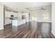 Open-concept kitchen with a large island, stainless steel appliances, and dark wood flooring at 9416 Bullfrog Court, Gibsonton, FL 33534