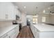 Kitchen features quartz countertops, stainless steel appliances, pendant lighting, and custom white cabinetry at 9416 Bullfrog Court, Gibsonton, FL 33534
