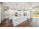 Bright kitchen featuring a white island with quartz countertops and stainless steel appliances at 9416 Bullfrog Court, Gibsonton, FL 33534