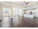 Expansive living room featuring hardwood floors, tray ceilings and an open layout to the kitchen at 9416 Bullfrog Court, Gibsonton, FL 33534