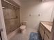 Bathroom with shower, tiled floors, vanity, and fixtures at 946 Madrid Dr, Palm Harbor, FL 34684