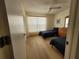 Bedroom with twin beds, hardwood floors, dresser, and a window at 946 Madrid Dr, Palm Harbor, FL 34684