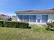 Charming home exterior featuring a well-maintained lawn and a neatly trimmed hedge at 946 Madrid Dr, Palm Harbor, FL 34684