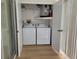 Convenient laundry room with a full-size washer and dryer set, ensuring easy laundry care at 946 Madrid Dr, Palm Harbor, FL 34684