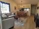 Open-concept living and dining area with wood floors and lots of natural light at 946 Madrid Dr, Palm Harbor, FL 34684