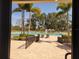 Lovely pool area with swaying palm trees and clear blue water, promising a refreshing retreat at 946 Madrid Dr, Palm Harbor, FL 34684