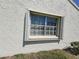Window with open shutters and bars offering ample light and outdoor views at 946 Madrid Dr, Palm Harbor, FL 34684