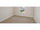 Small bedroom with neutral carpeting and one window allowing natural light at 9955 Surrey Rose Dr, San Antonio, FL 33576