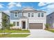 Charming two-story home featuring a well-manicured lawn and a two-car garage at 9955 Surrey Rose Dr, San Antonio, FL 33576