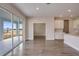 Open-concept living space features sliding glass doors, wood flooring, and a view to the kitchen at 9955 Surrey Rose Dr, San Antonio, FL 33576