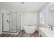 Bathroom with a glass shower, a modern soaking tub, and a single sink vanity at 9961 Surrey Rose Dr, San Antonio, FL 33576
