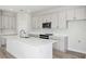 This kitchen features modern appliances, gray cabinets, and a large white island at 9961 Surrey Rose Dr, San Antonio, FL 33576