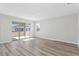 Bright living area featuring sliding doors leading to the outdoor space and hard surface floors at 9961 Surrey Rose Dr, San Antonio, FL 33576