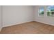 Bright bedroom featuring neutral carpet, baseboards, and a double window for natural light at 9989 Surrey Rose Dr, San Antonio, FL 33576