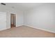 This carpeted bedroom offers a doorway view to the on-suite bathroom with good natural light at 9989 Surrey Rose Dr, San Antonio, FL 33576