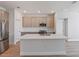 Spacious open kitchen with stainless steel appliances, center island, and modern cabinetry at 9989 Surrey Rose Dr, San Antonio, FL 33576