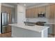 Modern kitchen featuring stainless steel appliances, ample storage, and a center island at 9989 Surrey Rose Dr, San Antonio, FL 33576