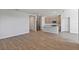Spacious open-concept floor plan with wood-look flooring and a view of the kitchen at 9989 Surrey Rose Dr, San Antonio, FL 33576